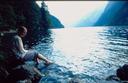 Ashe putting her feet in the water at our campsite along Berchtesgadens lake.